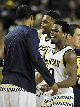 Zak Irvin (21) and Derrick Walton Jr. (10)