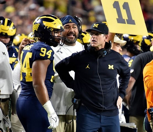 Kris Jenkins (94), Shaun Nua, and Jim Harbaugh