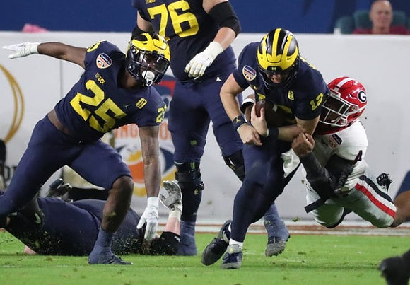 Hassan Haskins (25), Ryan Hayes (76), and Cade McNamara (12)