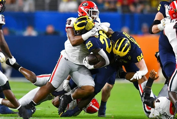 Hassan Haskins (25) and Joel Honigford (84)
