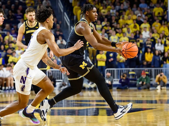 Hunter Dickinson (1) and Tarris Reed Jr. (32)