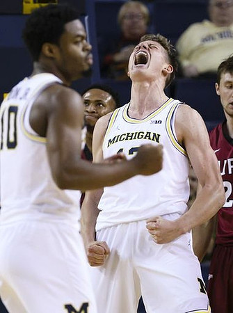 Derrick Walton Jr. (10) and Moritz Wagner (13)