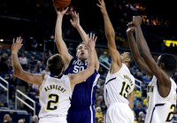 Spike Albrecht (2), Jon Horford (15), and Caris LeVert (23)