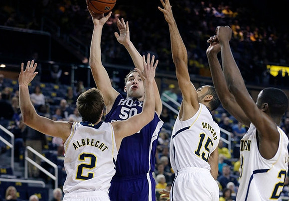 Spike Albrecht (2), Jon Horford (15), and Caris LeVert (23)