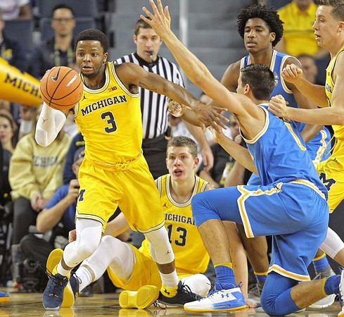 Zavier Simpson (3), Moritz Wagner (13), and Duncan Robinson (22)
