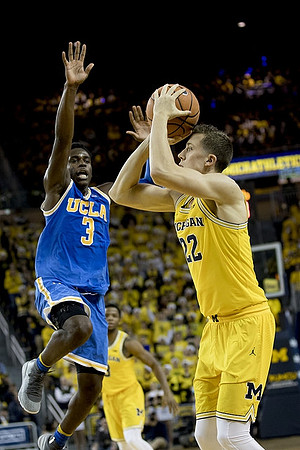 Duncan Robinson (22) and Zavier Simpson (3)