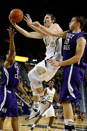 Nik Stauskas (11) and Caris LeVert (23)