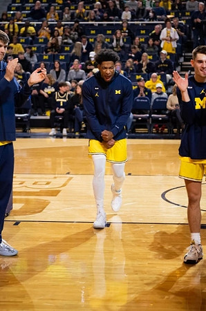 Jace Howard (25) and Michigan Team