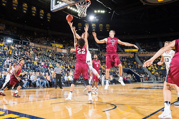 Derrick Walton Jr. (10), Mark Donnal (34), and Moritz Wagner (13)