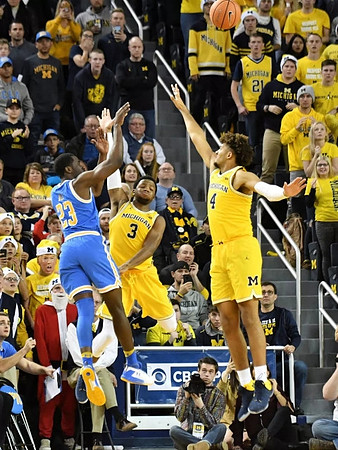 Zavier Simpson (3) and Isaiah Livers (4)