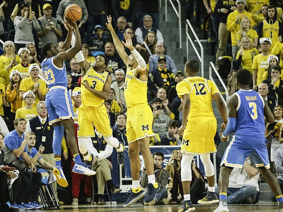 Zavier Simpson (3), Isaiah Livers (4), and Muhammad-Ali Abdur-Rahkman (12)