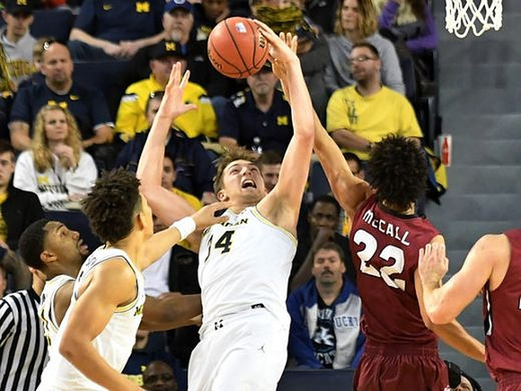 D.J. Wilson (5) and Mark Donnal (34)