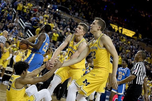 Eli Brooks (55), Moritz Wagner (13), and Duncan Robinson (22)