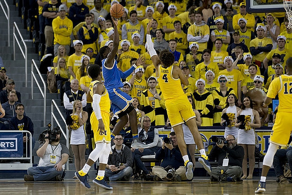 Zavier Simpson (3), Isaiah Livers (4), and Muhammad-Ali Abdur-Rahkman (12)