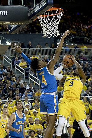 Duncan Robinson (22) and Zavier Simpson (3)