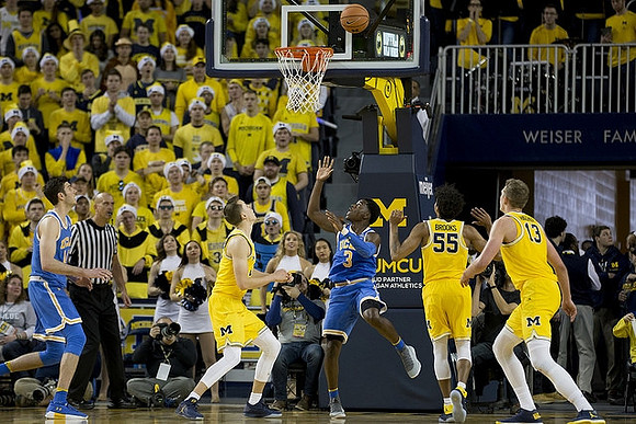 Duncan Robinson (22), Eli Brooks (55), and Moritz Wagner (13)