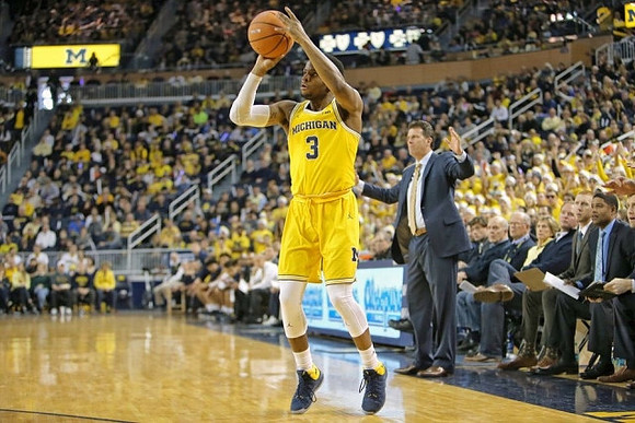 Zavier Simpson (3) and UCLA Head Coach Steve Alford