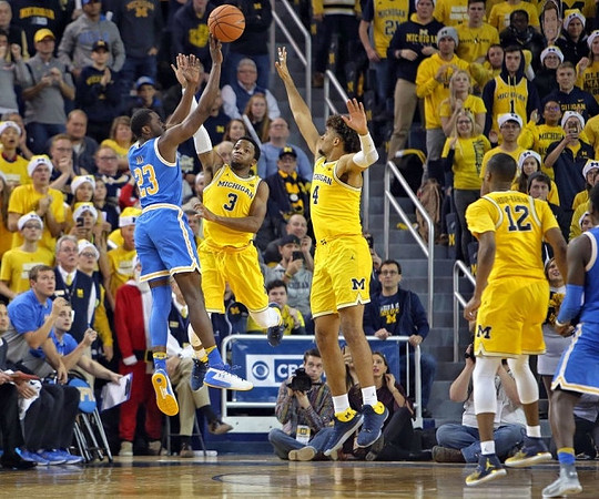 Zavier Simpson (3), Isaiah Livers (4), and Muhammad-Ali Abdur-Rahkman (12)
