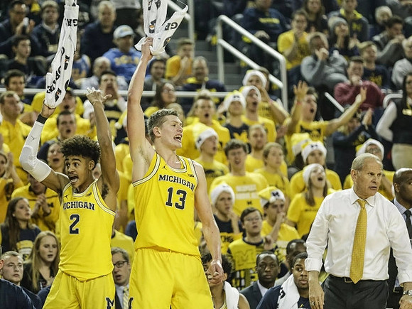 Jordan Poole (2), Moritz Wagner (13), and John Beilein