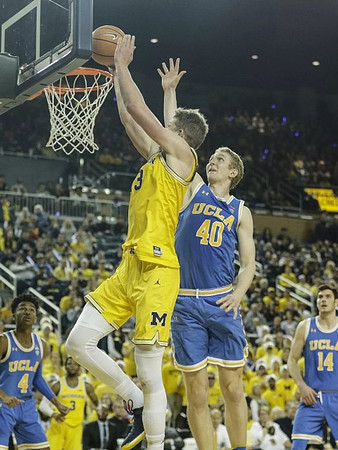 Moritz Wagner (13) and Zavier Simpson (3)