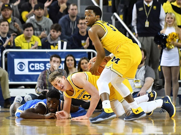 Moritz Wagner (13) and Zavier Simpson (3)