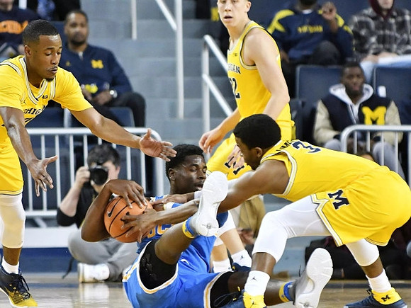 Muhammad-Ali Abdur-Rahkman (12), Zavier Simpson (3), and Moritz Wagner (13)