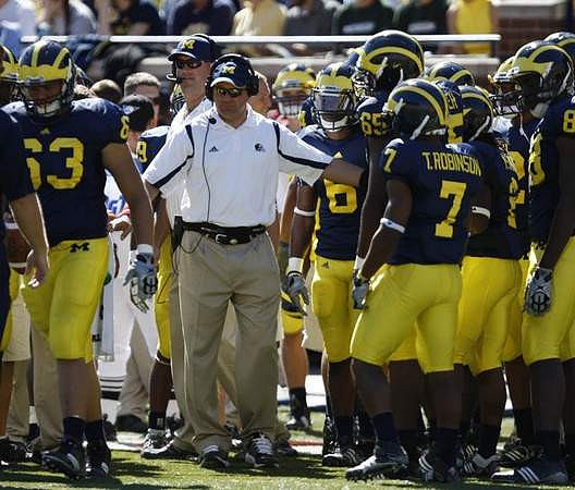 Rocko Khoury (63), Rich Rodriguez, and Terrence Robinson (7)