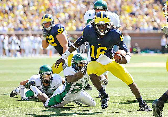 Denard Robinson (16) and Stephen Schilling (52)