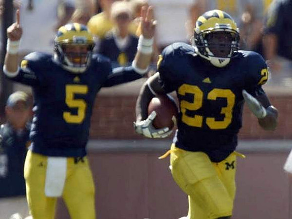 Tate Forcier (5) and Carlos Brown (23)