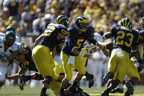 Stephen Schilling (52), Tate Forcier (5), and Carlos Brown (23)