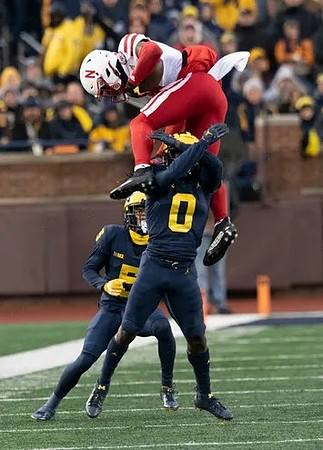 DJ Turner (5) and Mike Sainristil (0)