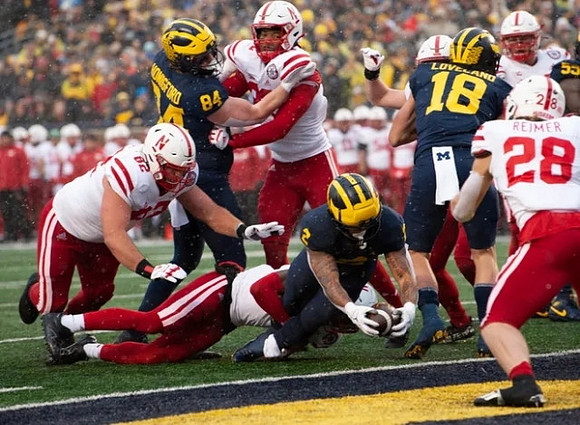 Joel Honigford (84), Blake Corum (2), Colston Loveland (18), and Olusegun Oluwatimi (55)