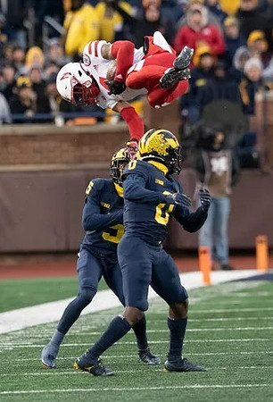 DJ Turner (5) and Mike Sainristil (0)