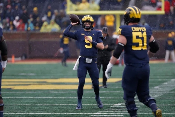 J.J. McCarthy (9) and Greg Crippen (51)