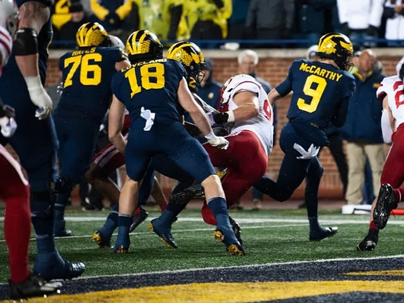 Ryan Hayes (76), Colston Loveland (18), Blake Corum (2), and J.J. McCarthy (9)
