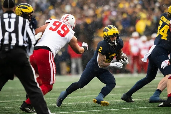 Blake Corum (2) and Joel Honigford (84)