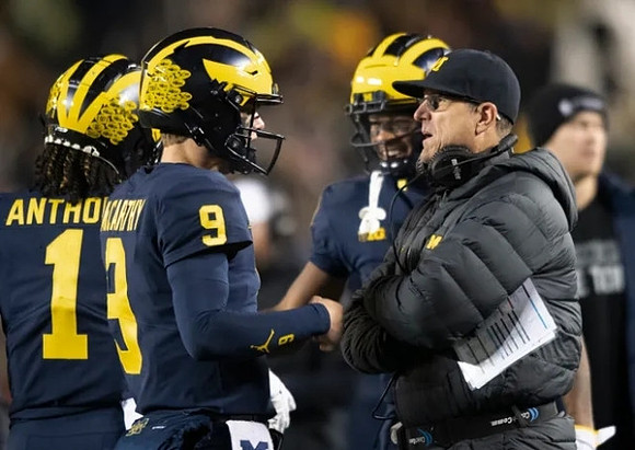 Andrel Anthony (1), J.J. McCarthy (9), and Jim Harbaugh
