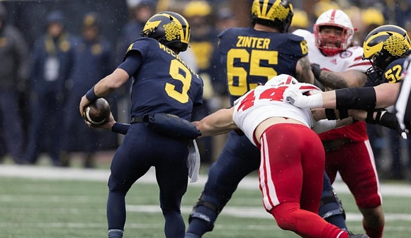 J.J. McCarthy (9), Zak Zinter (65), and Karsen Barnhart (52)