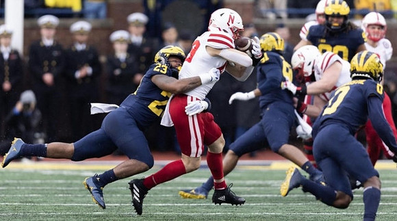 Michael Barrett (23), Taylor Upshaw (91), Mike Sainristil (0), and Mike Morris (90)