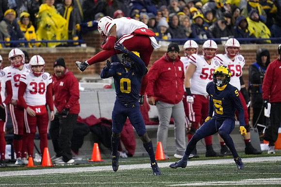 Mike Sainristil (0) and DJ Turner (5)
