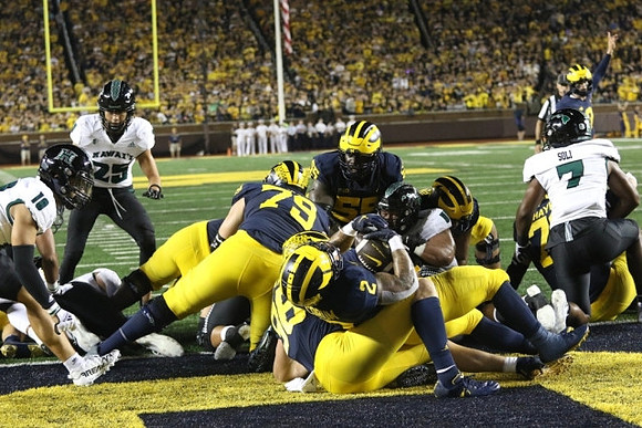Jeffrey Persi (79), Blake Corum (2), and Olusegun Oluwatimi (55)