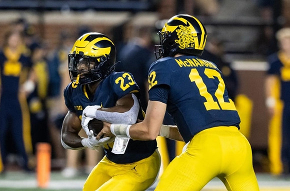 CJ Stokes (23) and Cade McNamara (12)