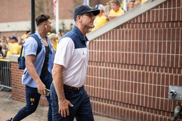 Erick All (83) and Jim Harbaugh