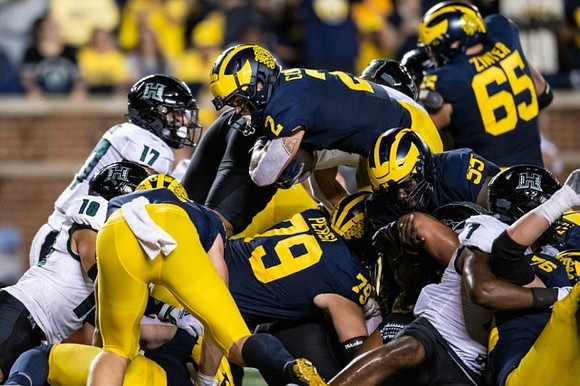 Blake Corum (2), Jeffrey Persi (79), Zak Zinter (65), Olusegun Oluwatimi (55), and Ryan Hayes (76)