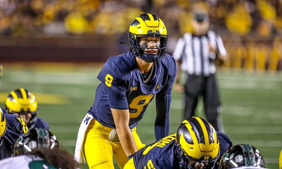 J.J. McCarthy (9) and Olusegun Oluwatimi (55)