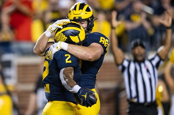 Blake Corum (2) and Luke Schoonmaker (86)