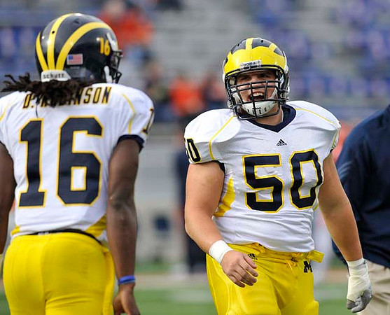 Denard Robinson (16) and David Molk (50)