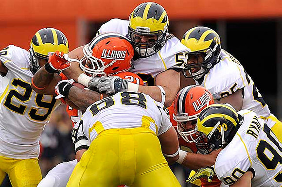 Troy Woolfolk (29), Mike Martin (68), Ryan Van Bergen (53), Jake Ryan (90), and Kenny Demens (25)