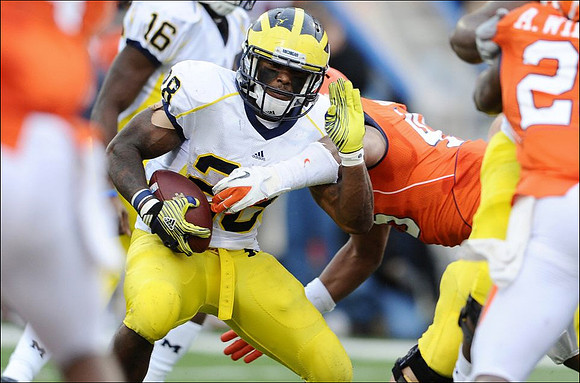 Denard Robinson (16) and Fitzgerald Toussaint (28)