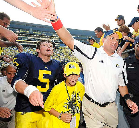 Tate Forcier (5) and Rich Rodriguez